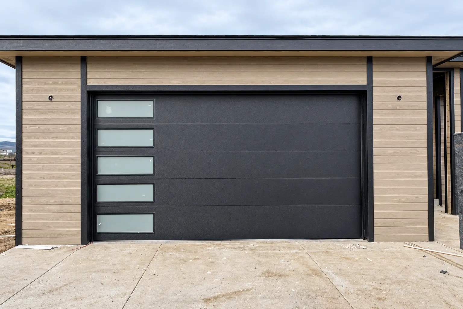 Wide charcoal garage door with vertical frosted windows